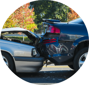 a silver vehicle rear-ending a black vehicle