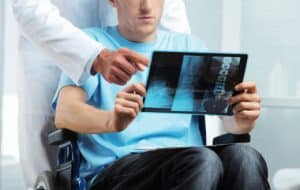 Chicago Catastrophic Injury Lawyer reviews spinal cord x-rays with Injury Patient.