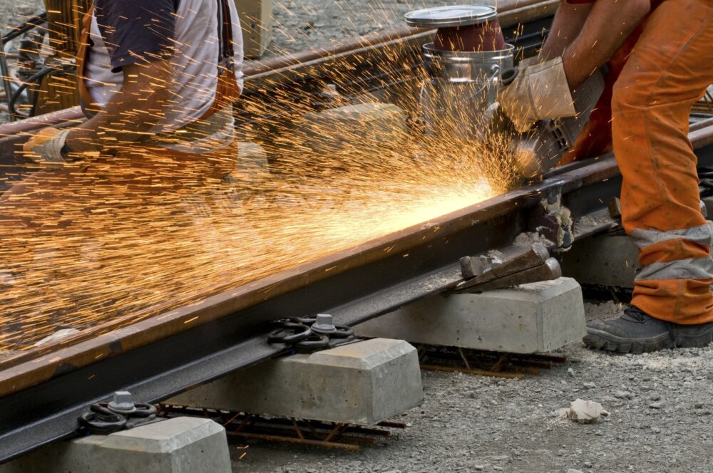 FELA protections, image of railroad workersusing welder.
