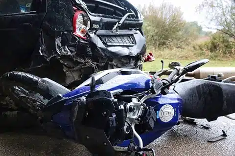 Motorcycle Accident Injuries, crashed bike next to crashed car, Disparti Law Group