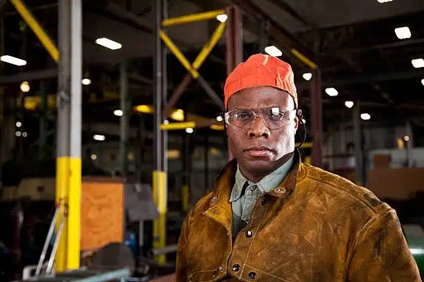 Chicago Employment Lawyer, image of african american worker in fabrication shop with orange cap, Disparti Law Group Accident & Injury Lawyers