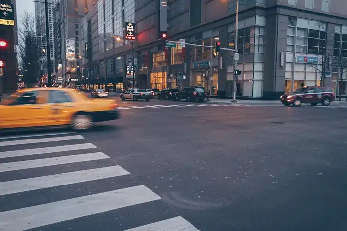 Most dangerous intersections motorcyclists should avoid, image of yellow taxi speeding through Dearborn intersection, Disparti Law Group Accident & Injury Lawyers