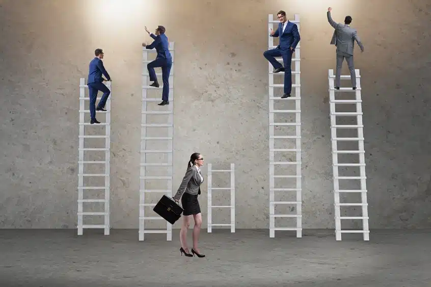 Chicago Employment discrimination lawyer, Image of four men in suits climbing tall ladder and woman in a suit walking to short ladder, Disparti Law Group