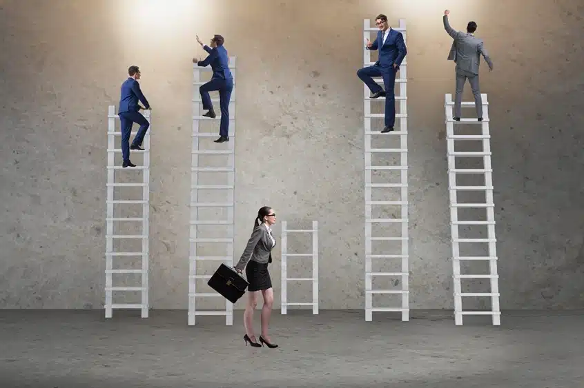 Chicago Employment discrimination lawyer, Image of four men in suits climbing tall ladder and woman in a suit walking to short ladder, Disparti Law Group Accident & Injury Lawyers