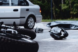 motorcycle lawyer Chicago, IL with a crashed motorcycle next to a car