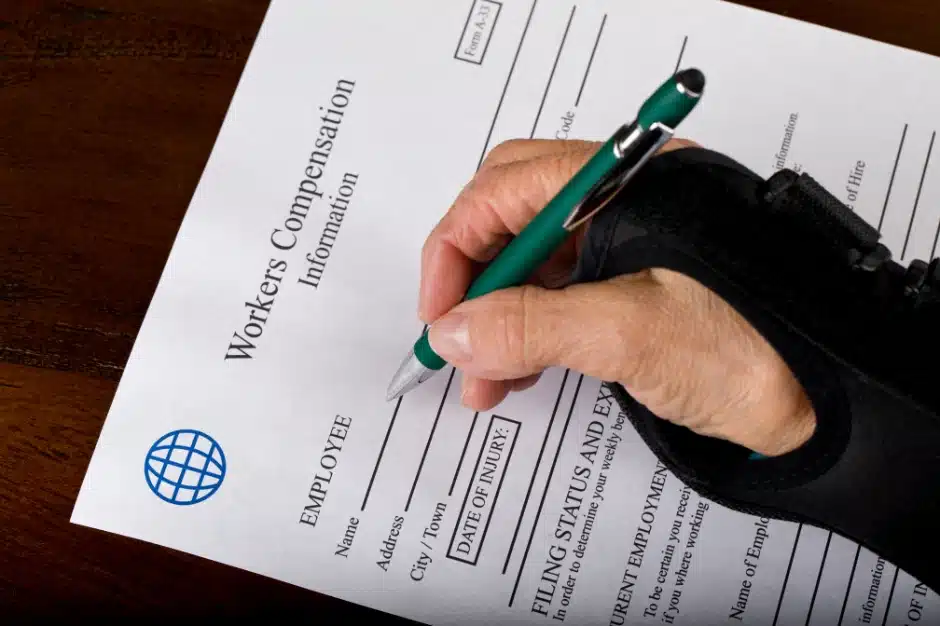 workers' compensation attorney, image of sprained wrist writing on workers comp forms
