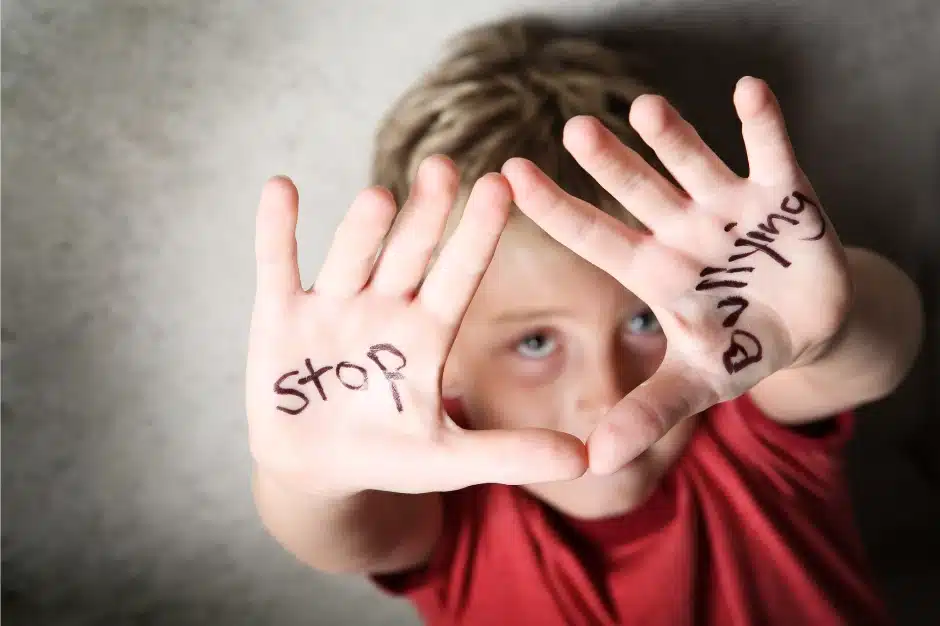 New Illinois anti-bullying policy, Image of child with stop bullying written on hands, Disparti Law Group