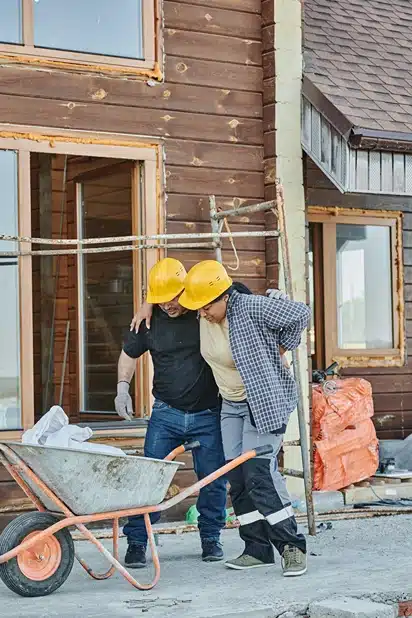 Injured union workers, image of construction worker helping an injured worker