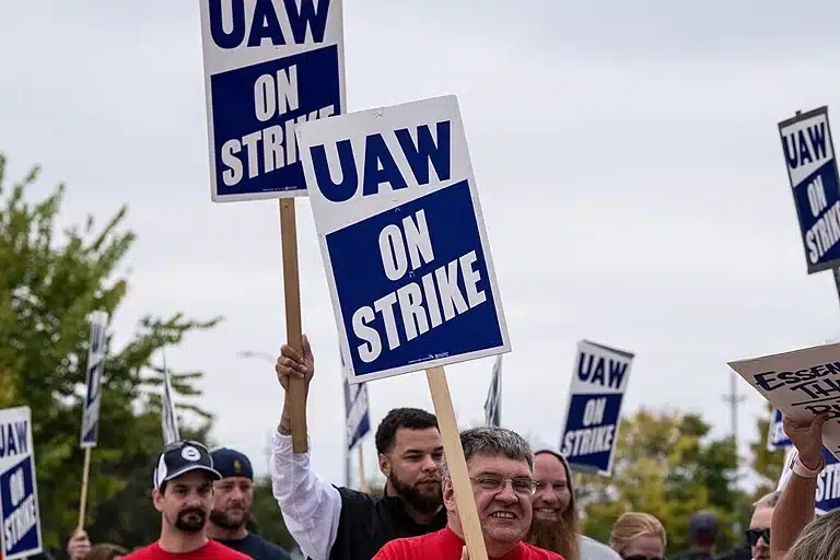 Union members at UAW strike with picket signs