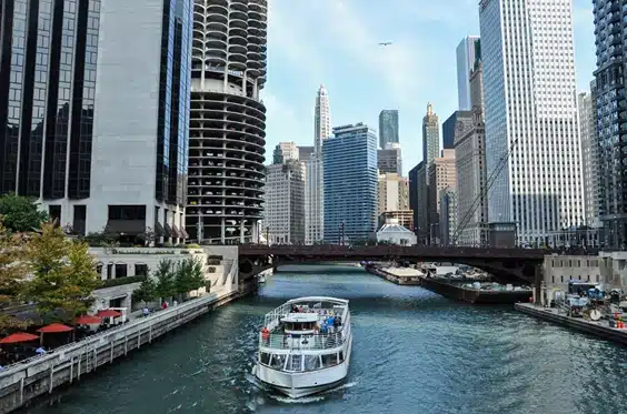 Chicago boat accident lawyer, image of boat sailing in river near chicago buildings, DIsparti Law Group