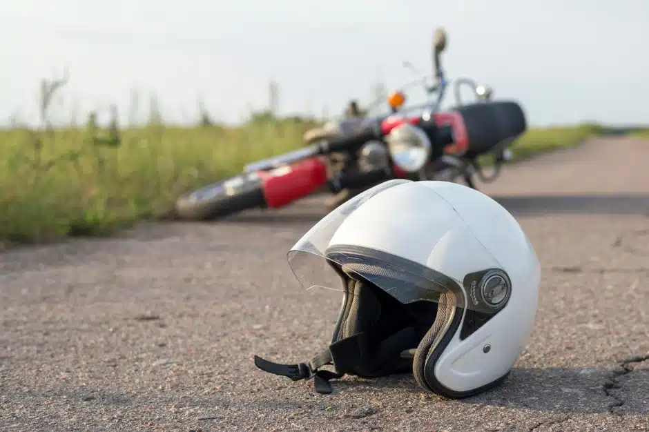 image of motorcycle helmet on the road next to motorcycle, motorcycle safety gear
