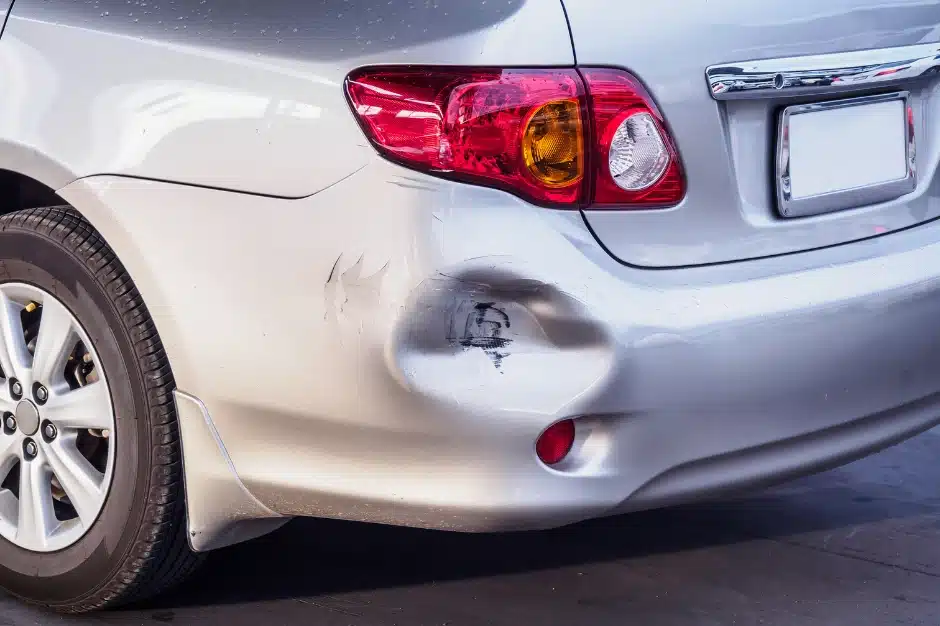 someone hit my parked car, Disparti Law Group, image of dent in back bumper on car
