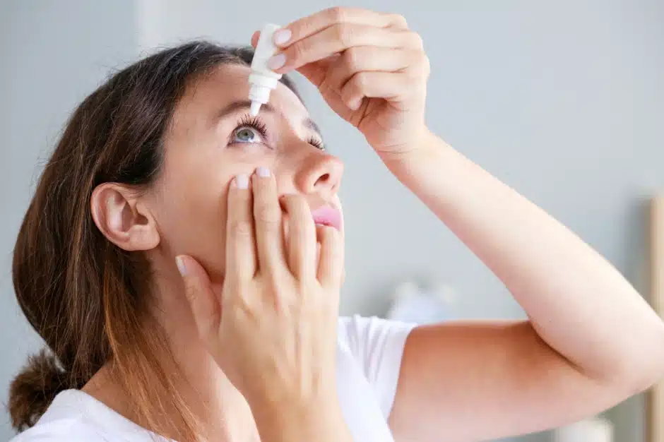 woman putting eye drops in eye, eye care product recall, Disparti Law Group